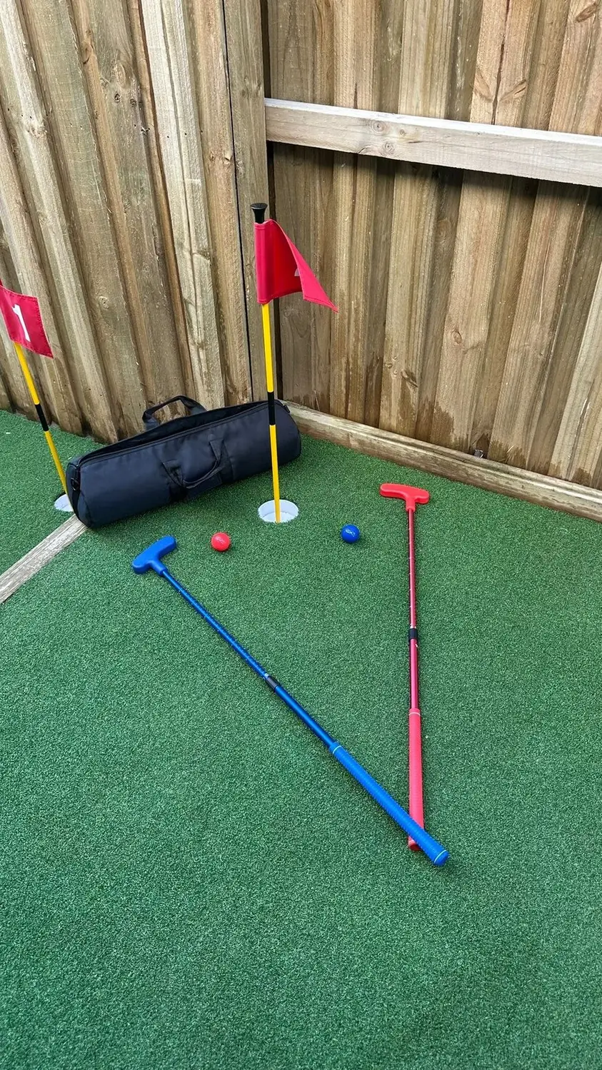Backyard putting green with flags and putters